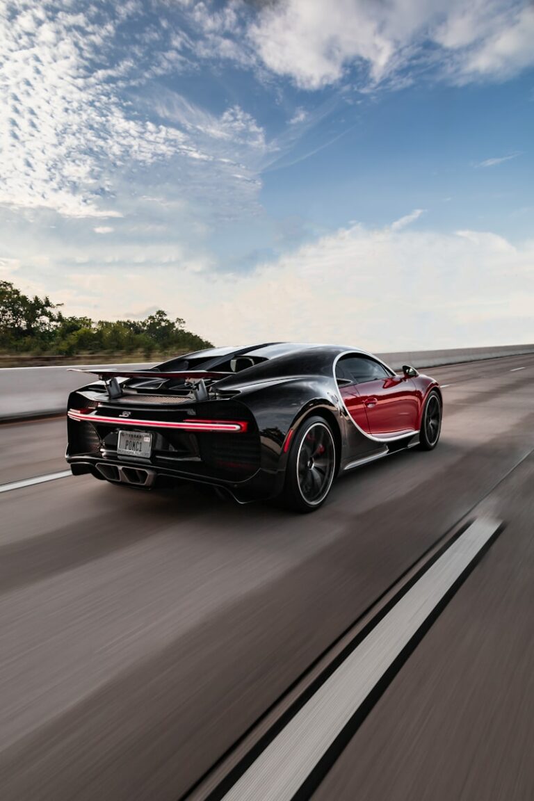 a black and red sports car driving down the road